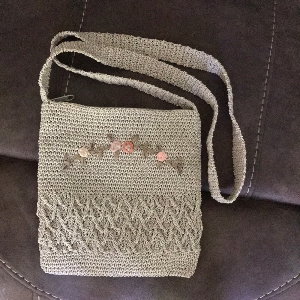 Bag with embroidered flowers on front of bag.